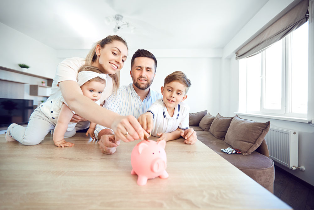 Family gathered around piggy bank